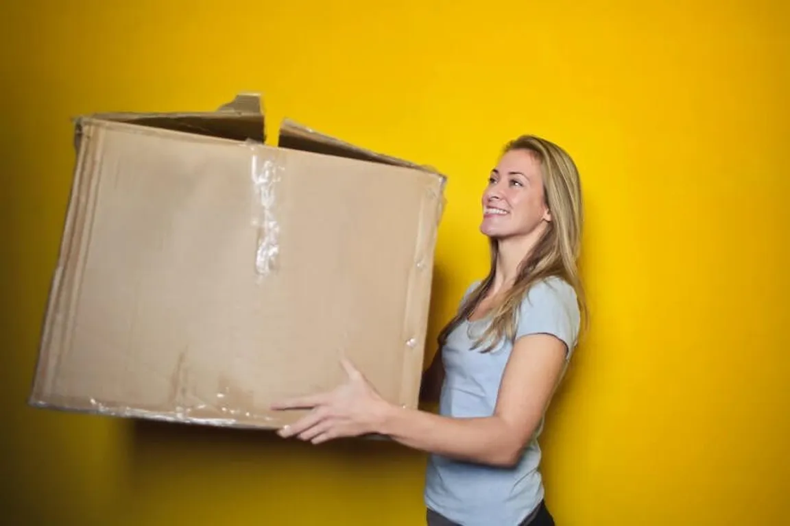 Woman with box relocating in Texas