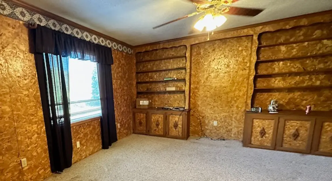 living room with walls made from sub flooring