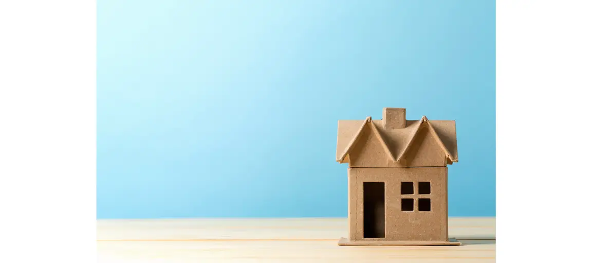 Brown house with a blue background.