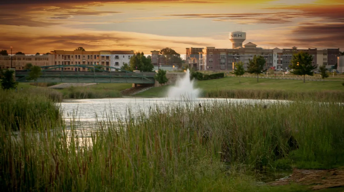 North Richland Hills photo with sunset and fountain in lake with city offices and water tower in background