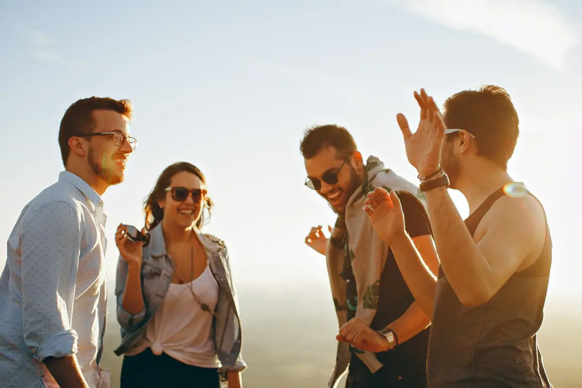 Pros and Cons of Owning a Vacation Rental in [market_city] or Cincinnati - People hanging out.