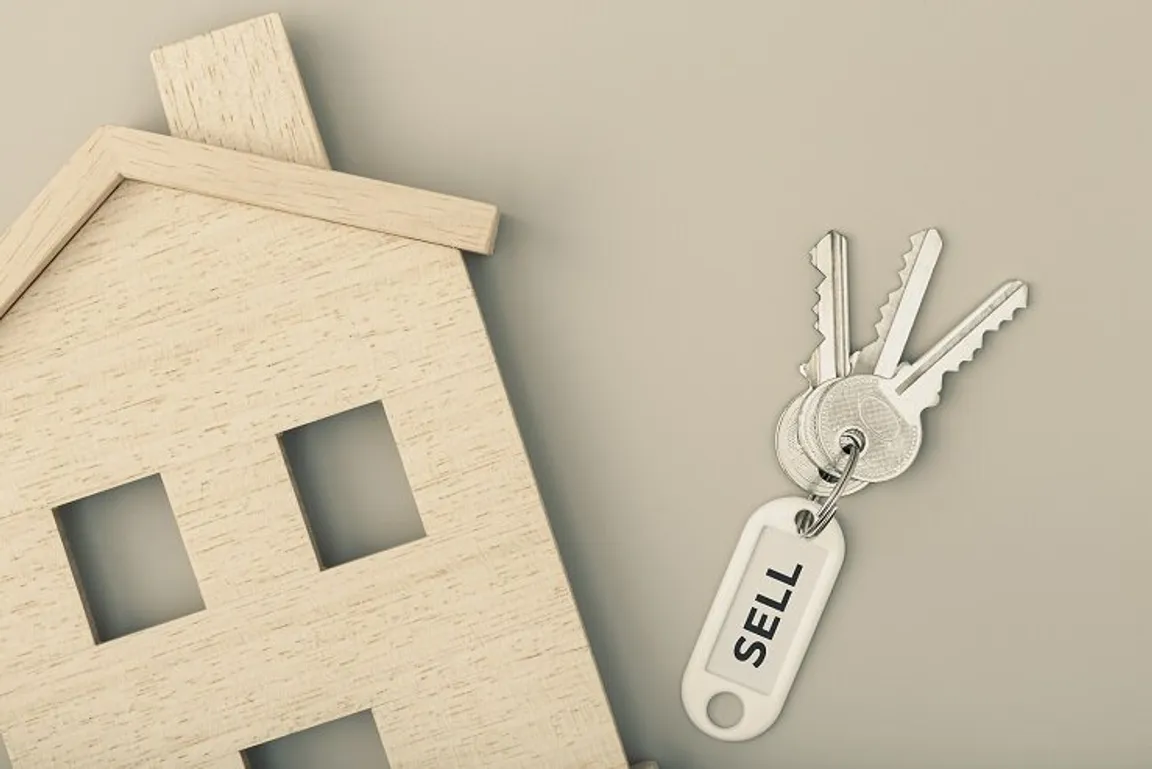 Selling a house concept. Real estate market. House icon with keys. Copy space. Top view