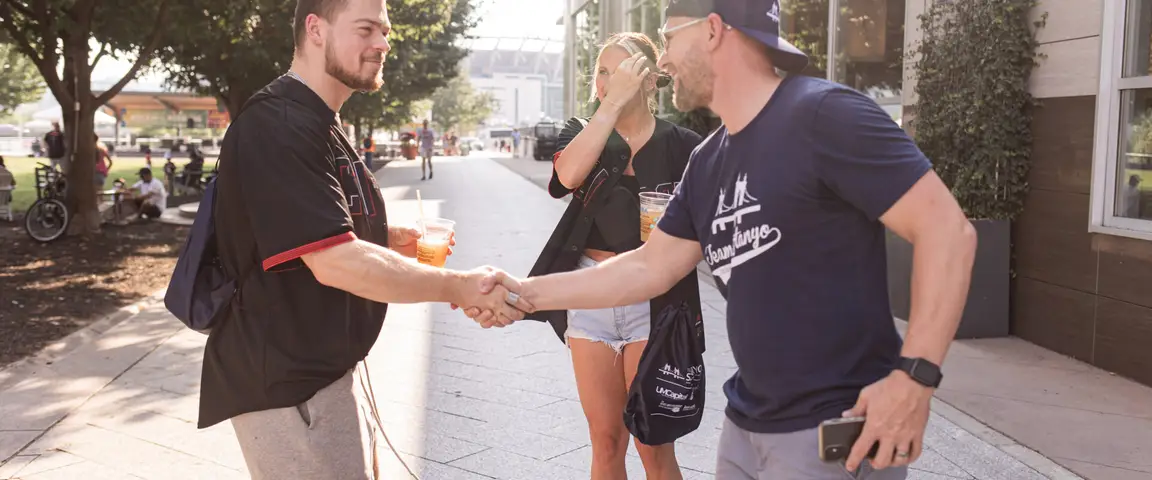Team Sztanyo Reds Game - Eric Sztanyo shaking hands with home buyer client