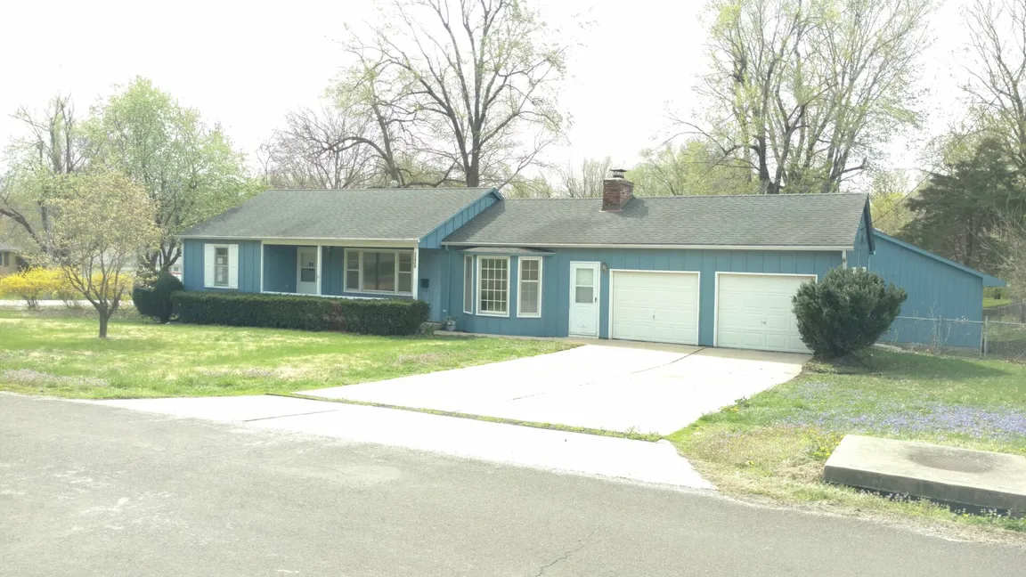 Blue house in raytown with 2 car garage