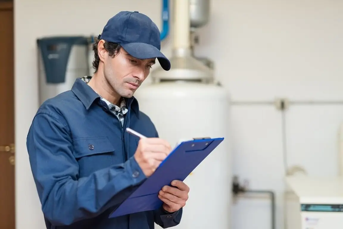Technician,Servicing,An,Hot-water,Heater