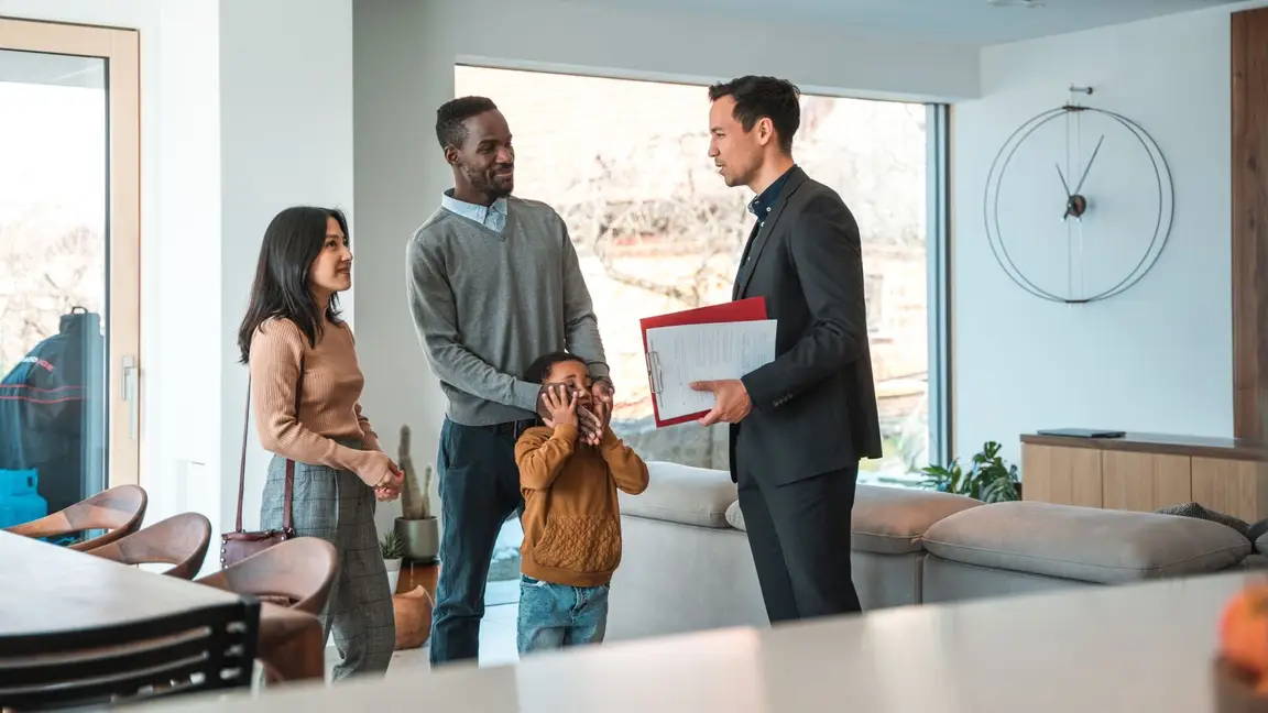A family talking to a real estate agent