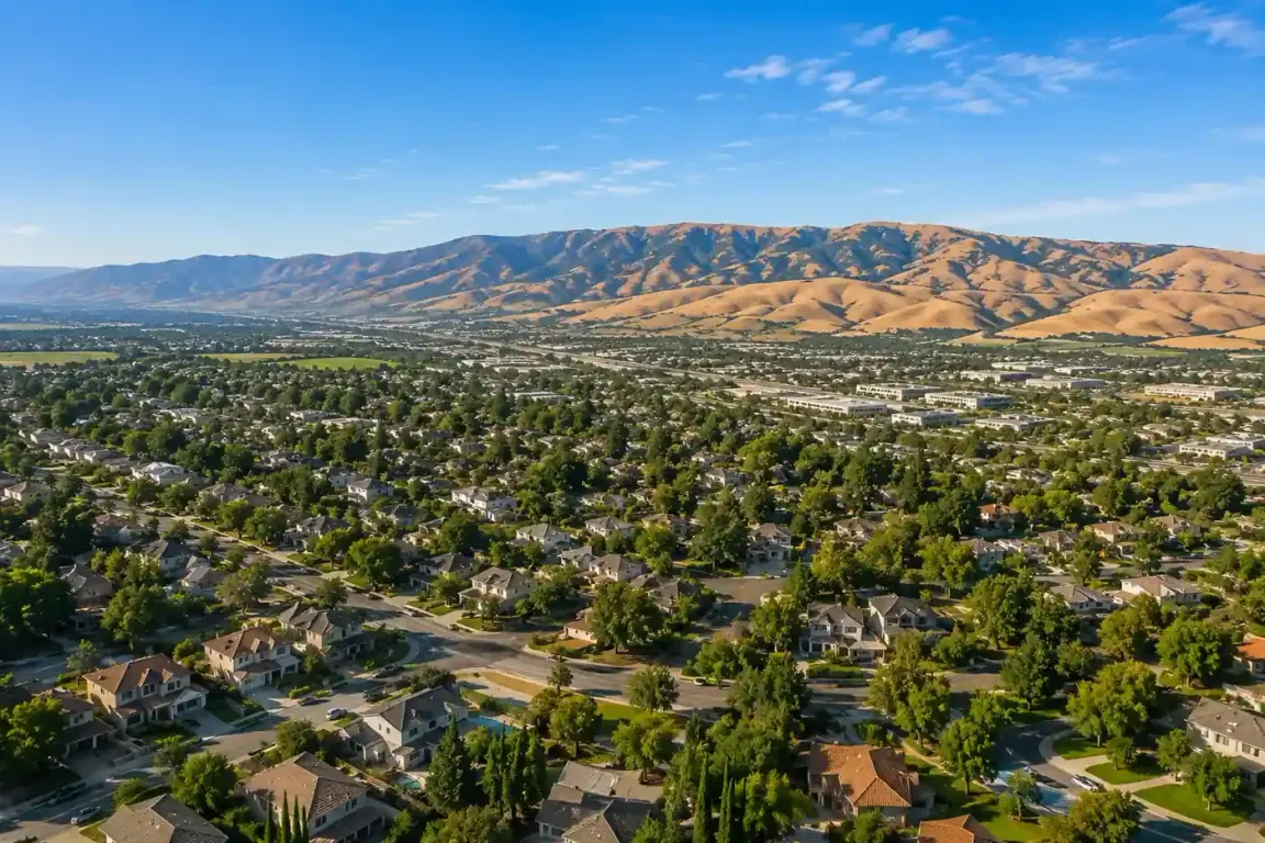 Aerial hero image of Livermore CA neighborhoods with the Altamont Pass hills in the background for a sell my house fast cash home buyers
