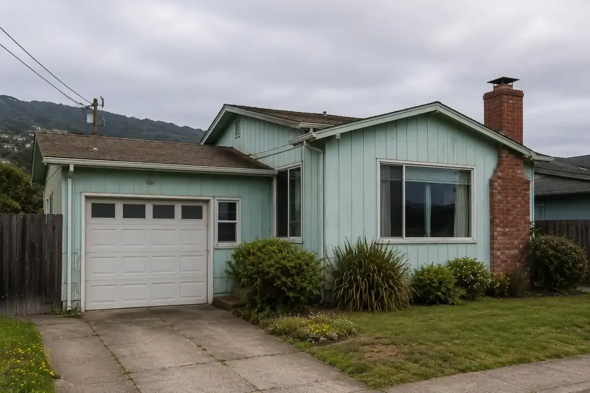 Original condition coastal home in Pacifica California with overcast skies and hillside backdrop for a sell my house fast Pacifica CA cash home buyer