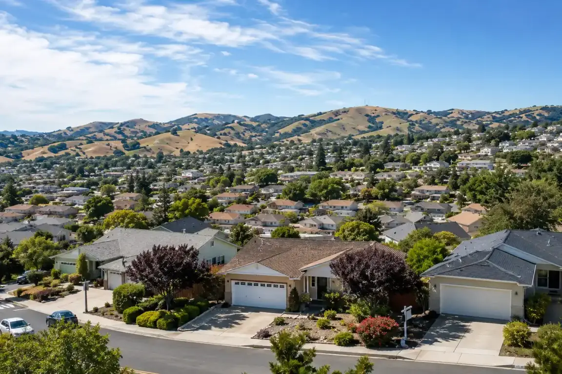Sell my house fast Pittsburg CA. Pittsburg California hillside neighborhood hero image with suburban homes and rolling East Bay hills.