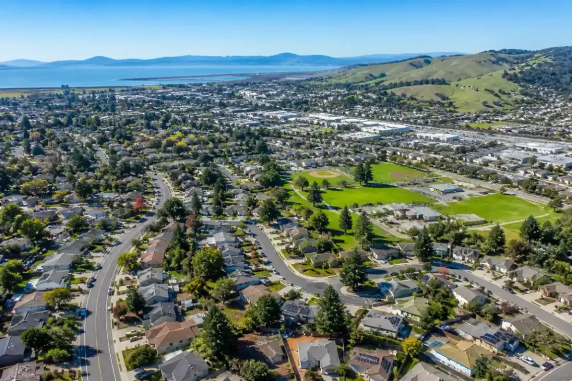 Aerial view of American Canyon California neighborhood showing homes and surrounding hills where homeowners can sell your house fast without repairs. We buy houses
