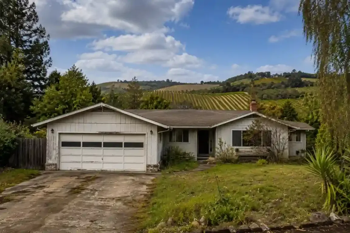 Sell my house fast Windsor CA fixer upper home with vineyard hills and Sonoma County scenery in the background.