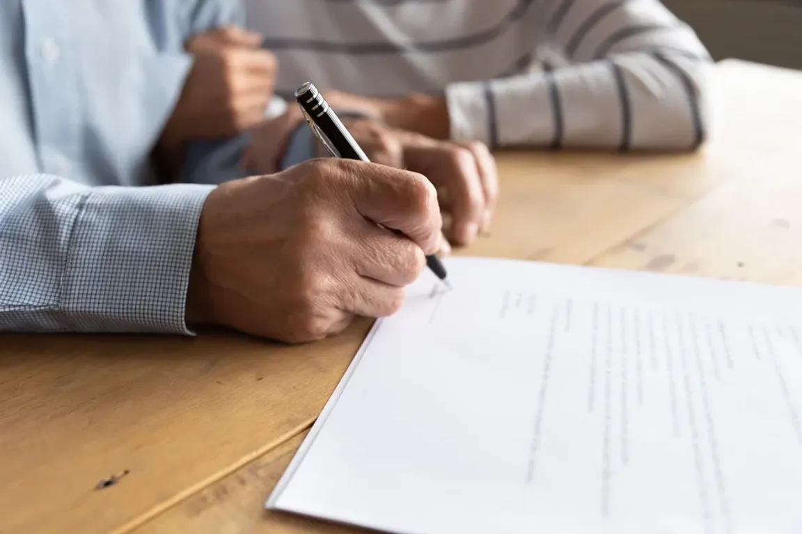 Couple signing paper