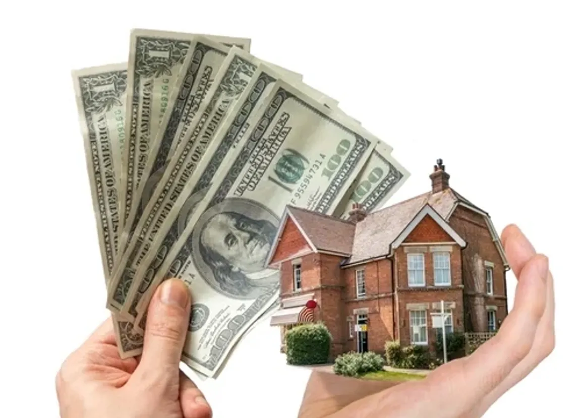 Hand holding house and money