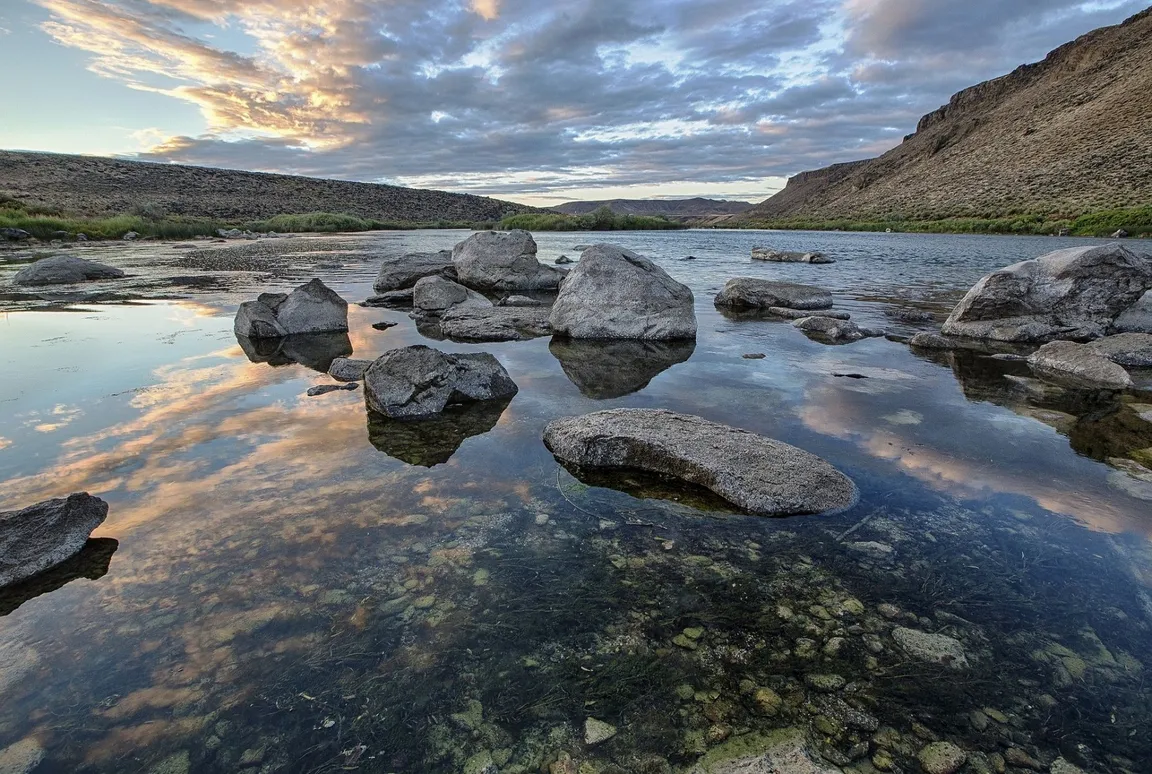 Scenery of river with rocks and sky.