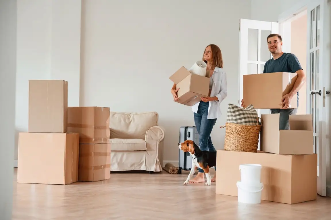 man and woman moving into new home