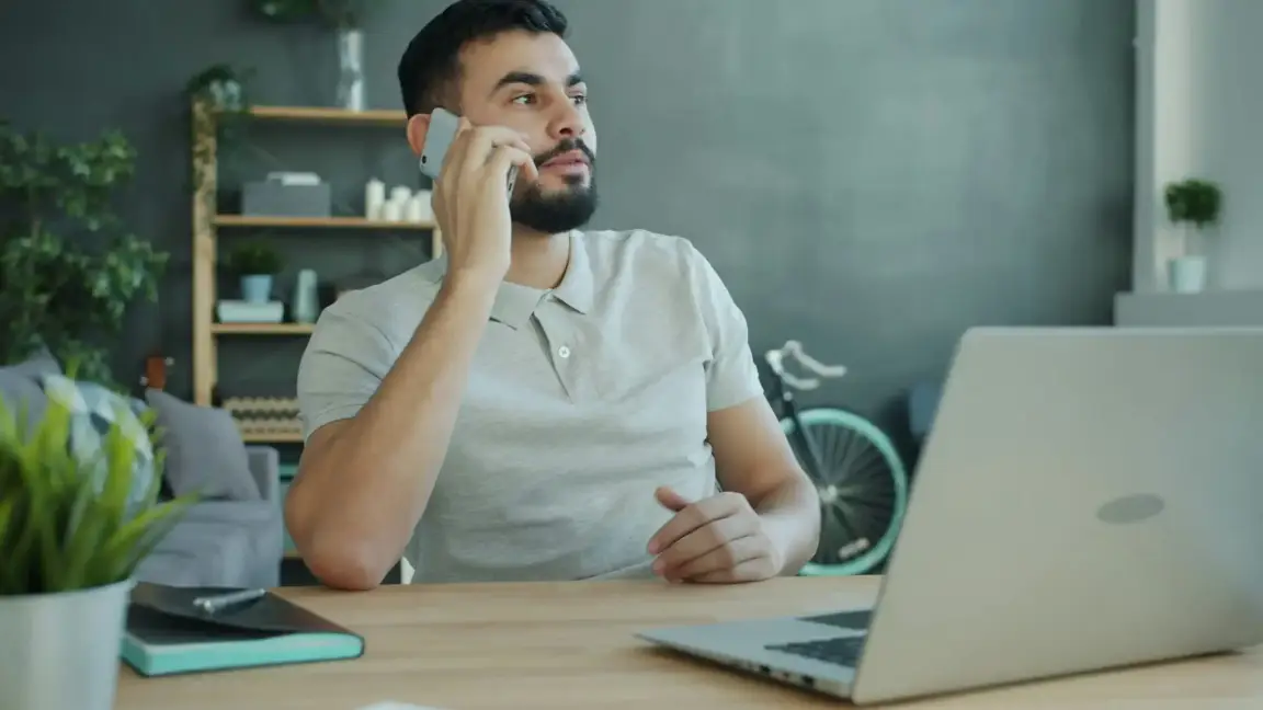 man talking on phone to sell house