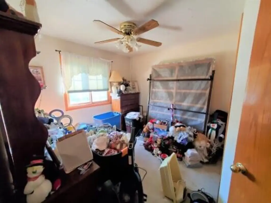 A room filled with stuff in an as-is home purchase by Anna Buys Houses.