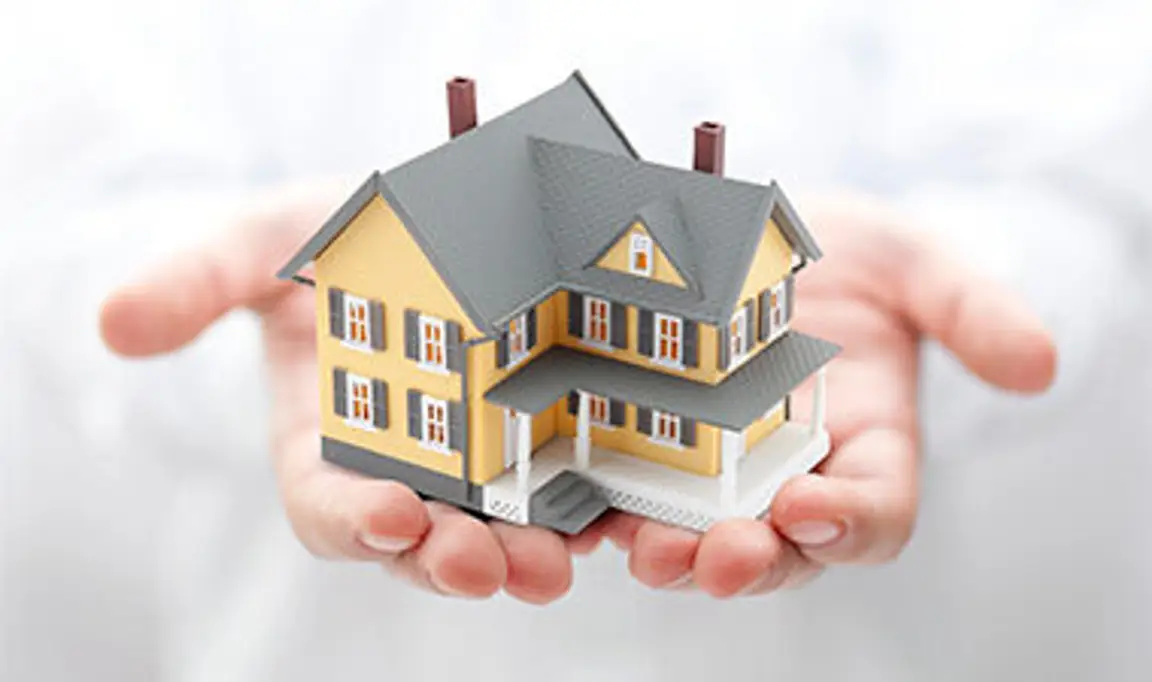 A house being held in someone's hands