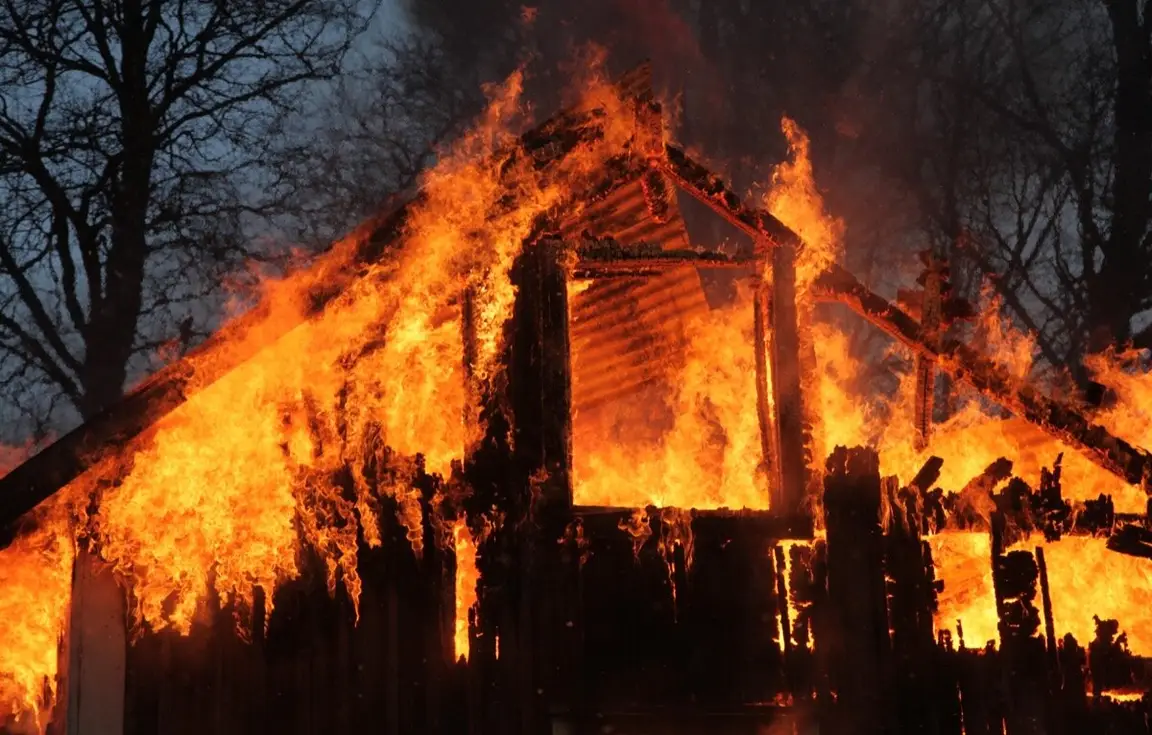House fully engulfed in flames at night