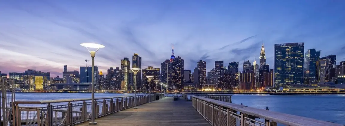 New York City skyline at dusk seen from a Brooklyn pier