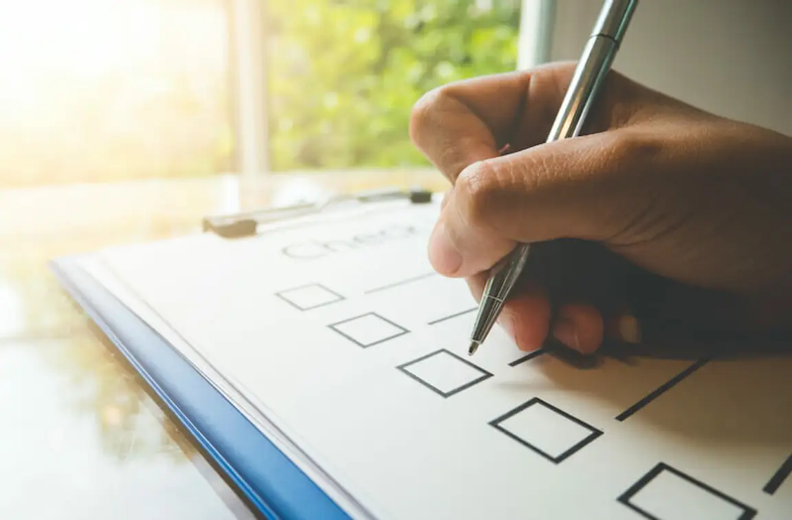 hand on a checklist
