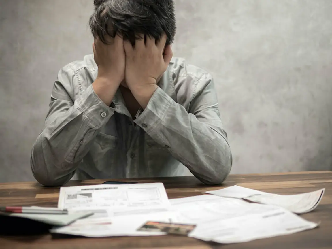 a worried man because he is behind in mortgage payments in Louisville