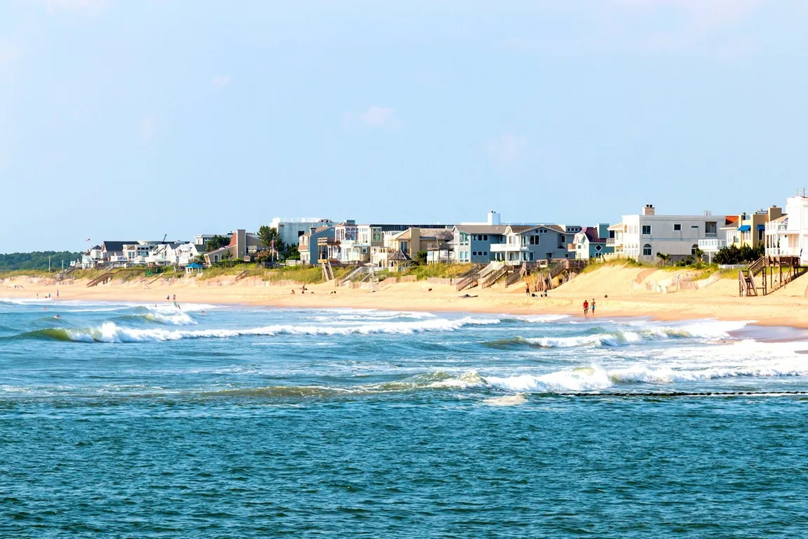 Virginia beach shoreline during the day with beach houses in the distance