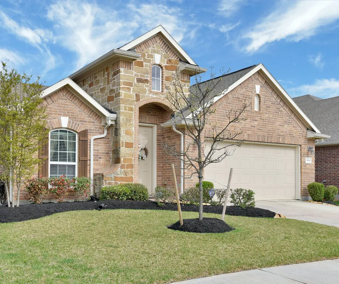 two-story tan brick house