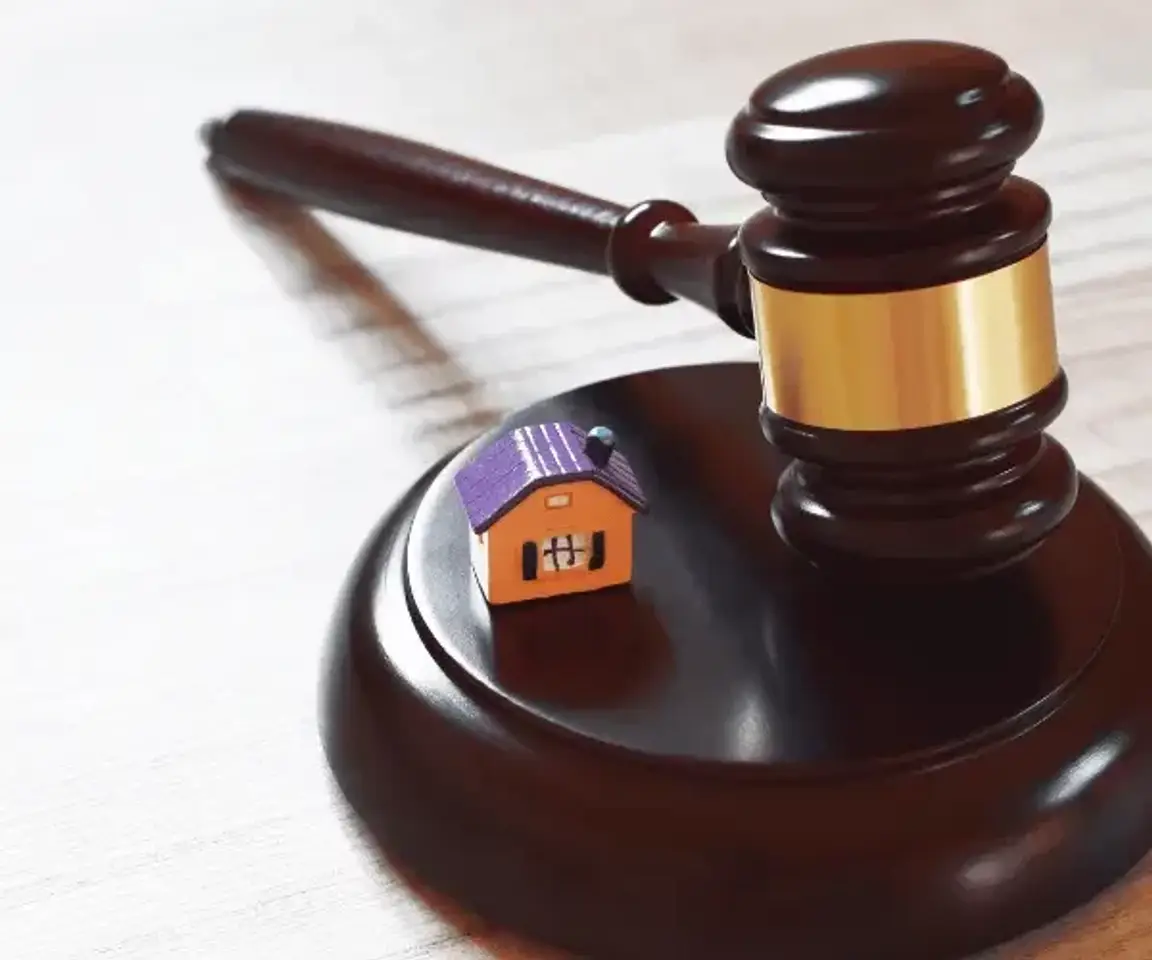 Real estate legal decision symbolized by a gavel and house.