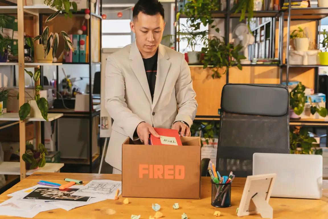 Employee packing belongings after losing a job.