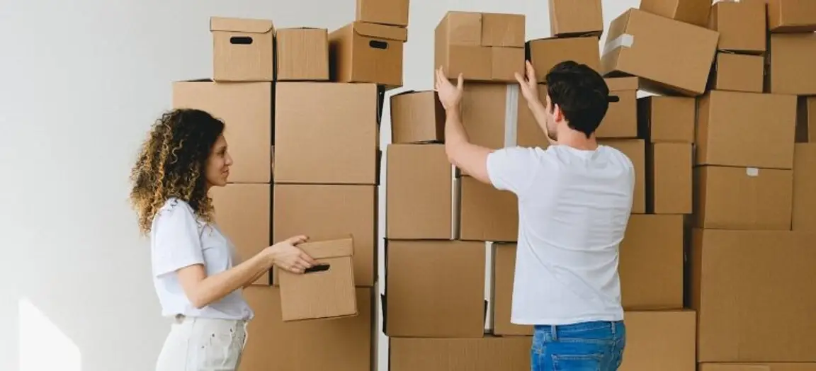 Man and woman arranging boxes