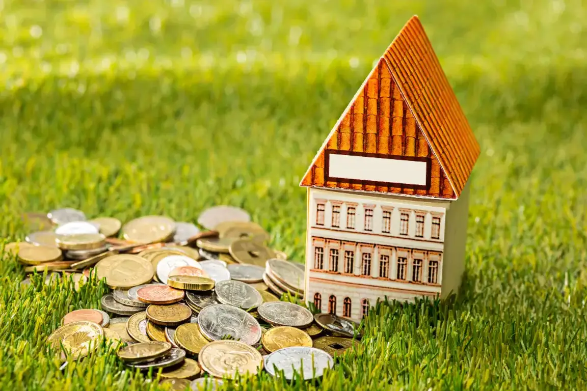 A wooden house besides a lot of coins