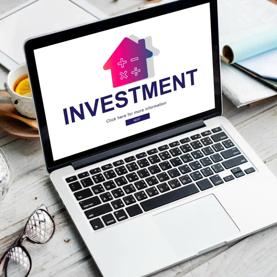 Laptop with the word investment on it.