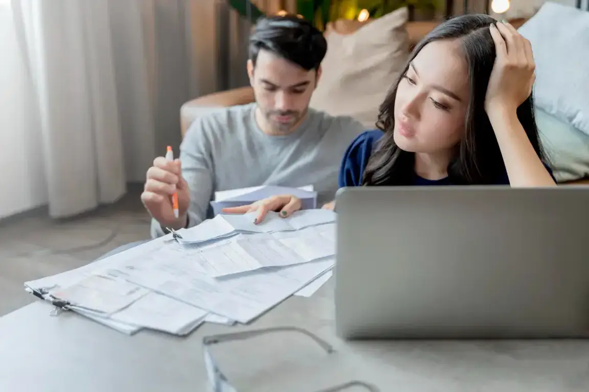 A man and a woman worrying about some papers