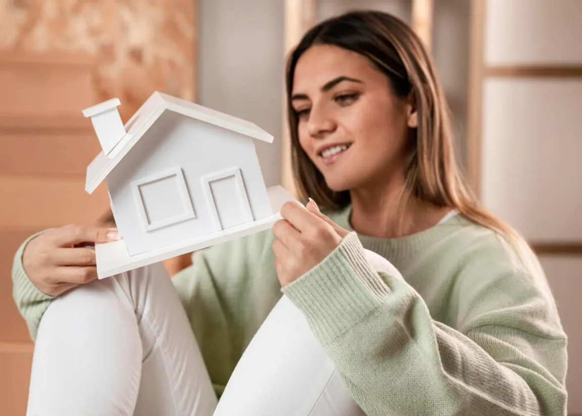 Woman holding a house