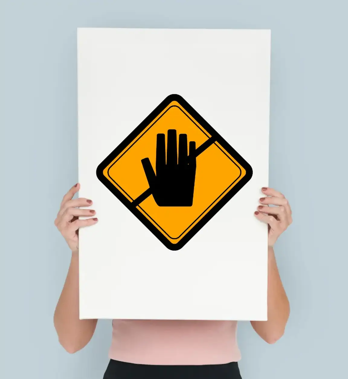 a woman holding up a sign with a hand on it