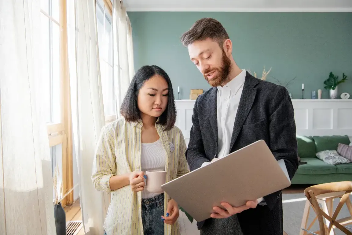 a man in a suit and an asian woman