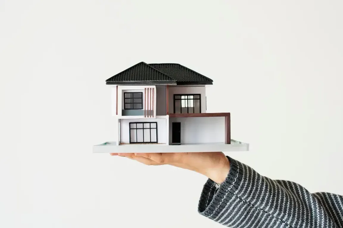 Man holding a house