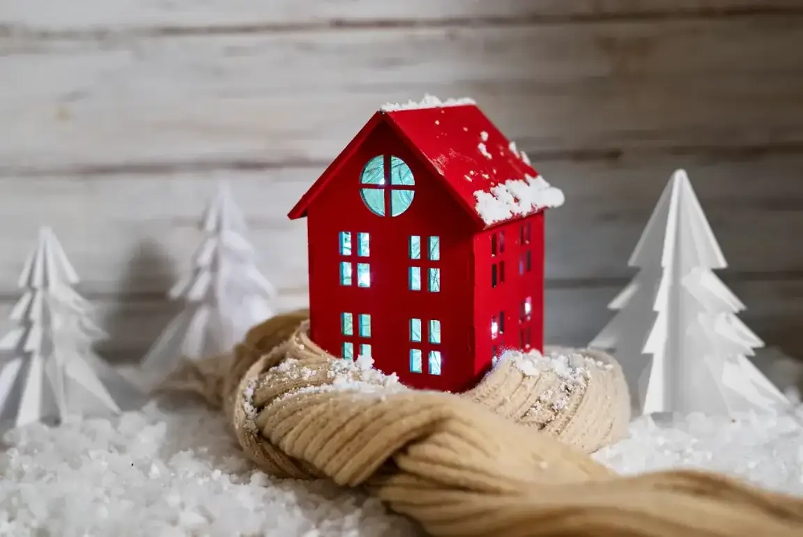 a red house sitting on top of a pile of snow