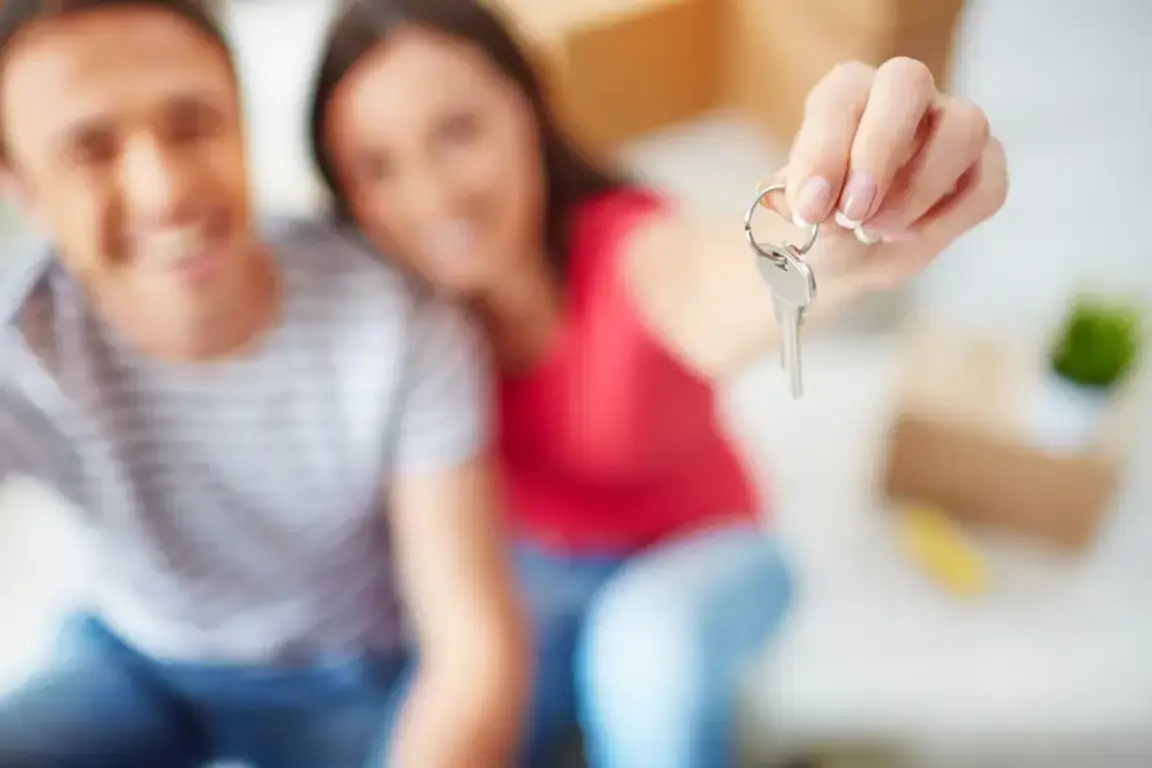 Man and a woman holding a key