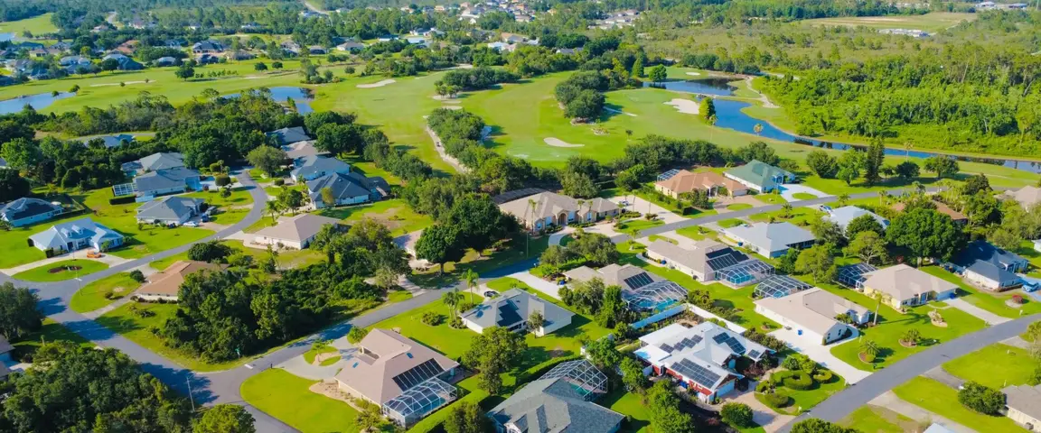 Aerial view of premium residential infill lots and luxury homes surrounding a golf course community in Florida.