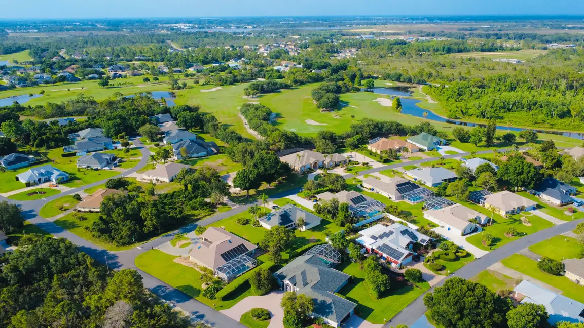 Aerial view of premium residential infill lots and luxury homes surrounding a golf course community in Florida.