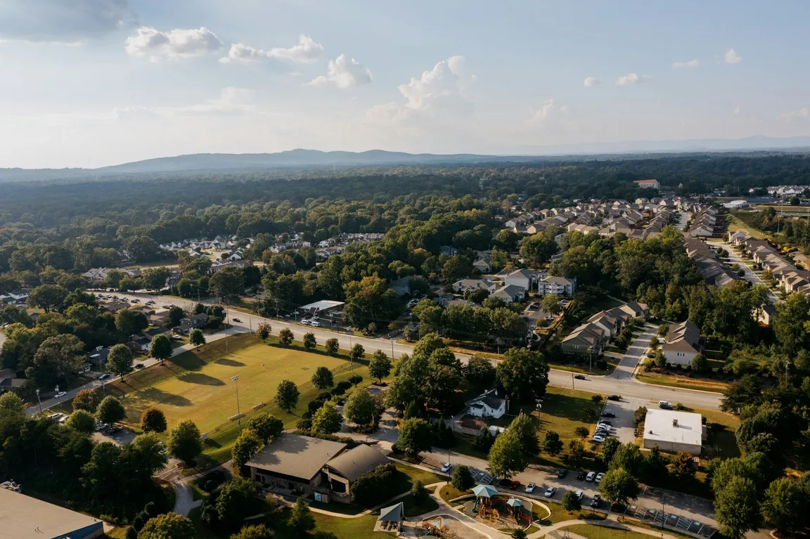 Aerial view of a residential neighborhood with mountains on the horizon