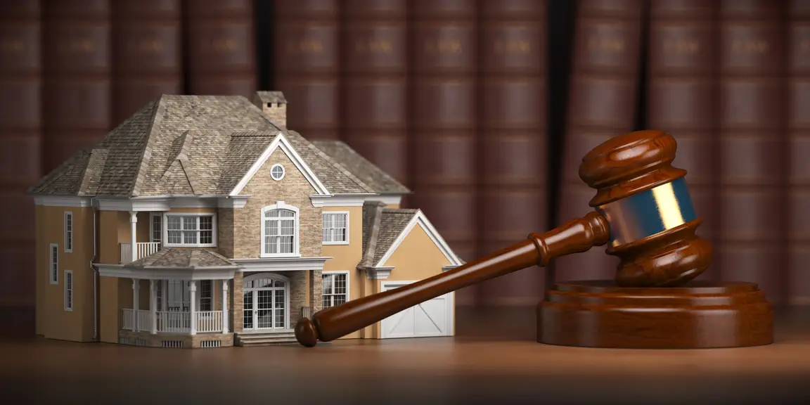 Real estate law and house sale with liens - gavel and law books