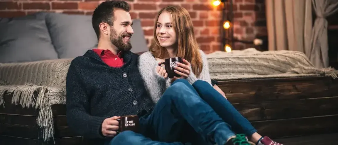 Happy white couple sitting indoors