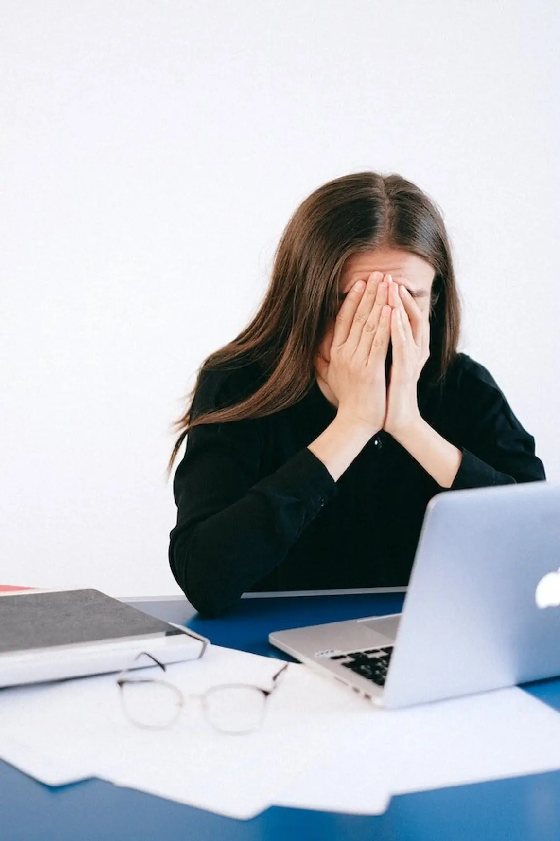 woman looking worried at past due bills