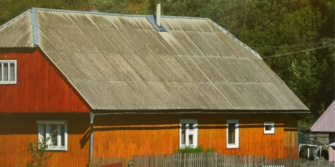 older home with corrugated roof representing potential asbestos materials in Oregon