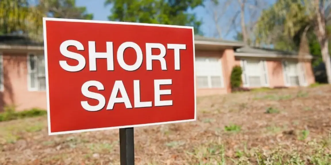 red ‘short sale’ sign in front of a house in [market_city]