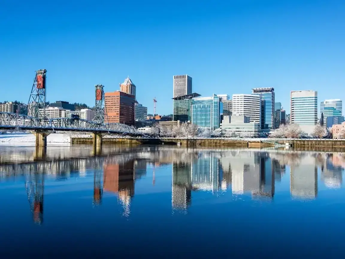 downtown Portland skyline with bridge and waterfront reflection