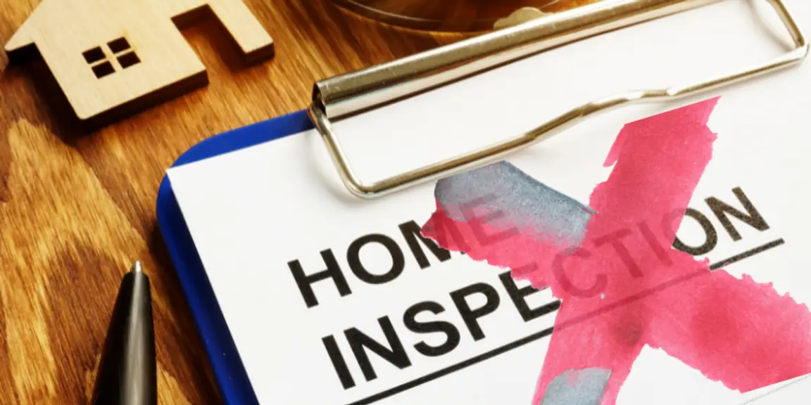 Home inspection checklist on a clipboard for residential property evaluation.
